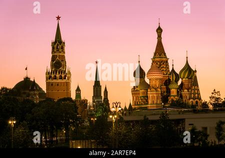 Moscow Kremlin and St Basil`s Cathedral at dusk, Russia. This place is a top tourist attraction of Moscow. Evening view of the Moscow landmarks in sum Stock Photo